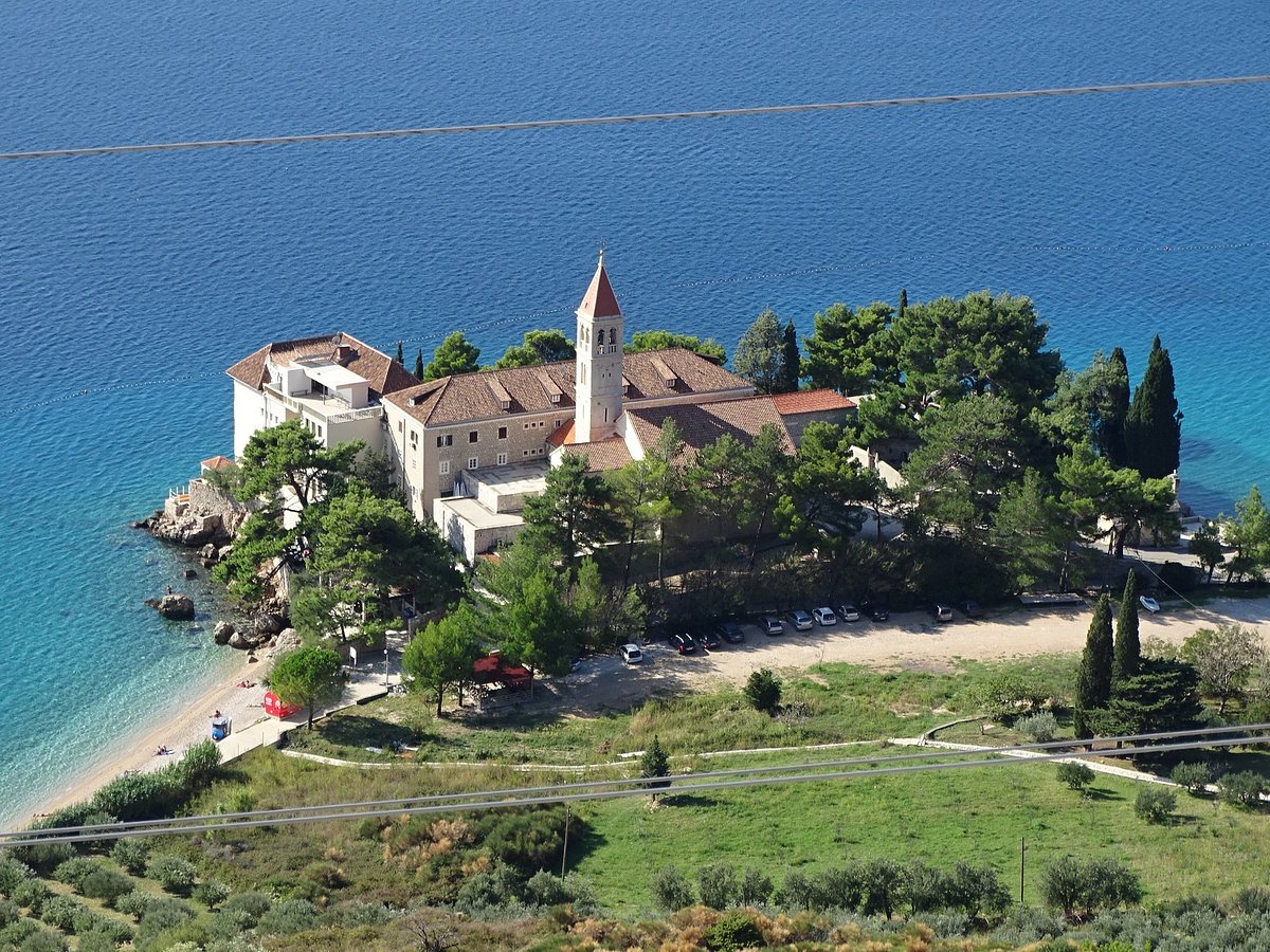 Dominican Monastery in Bol, Brač, Croatia, surrounded by lush greenery and overlooking the Adriatic Sea