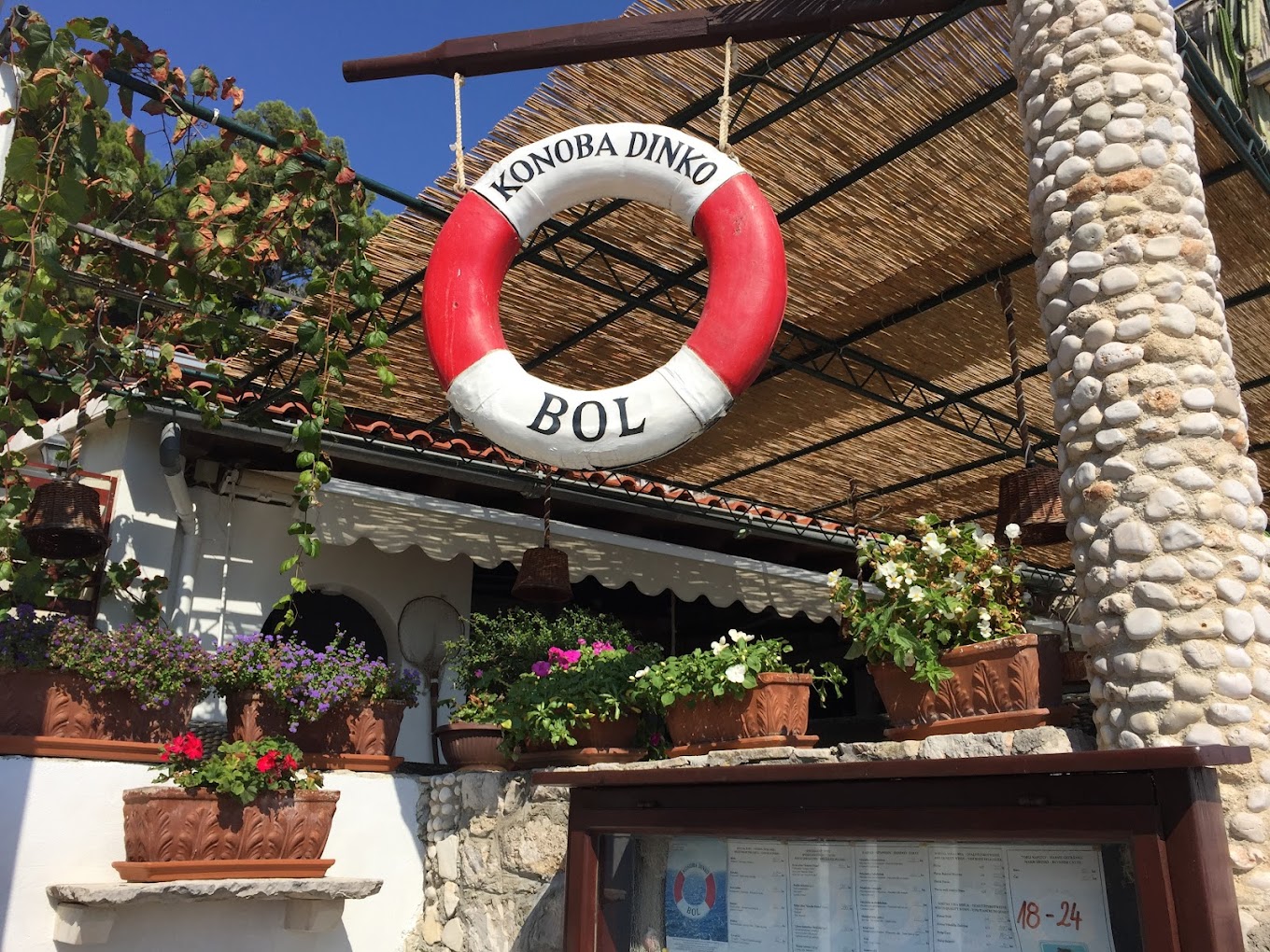 Restaurant Konoba Dinko Sign with Flowers in Coastal Croatia